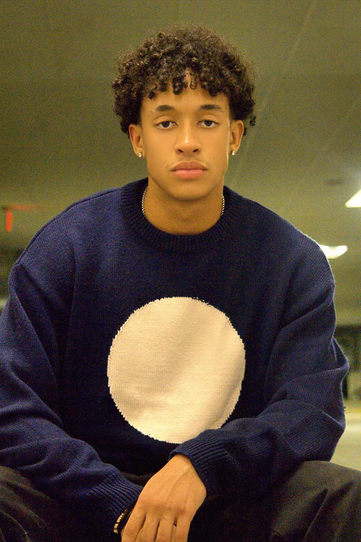 Close portrait of the Merino Knit worn in a parking garage at night.